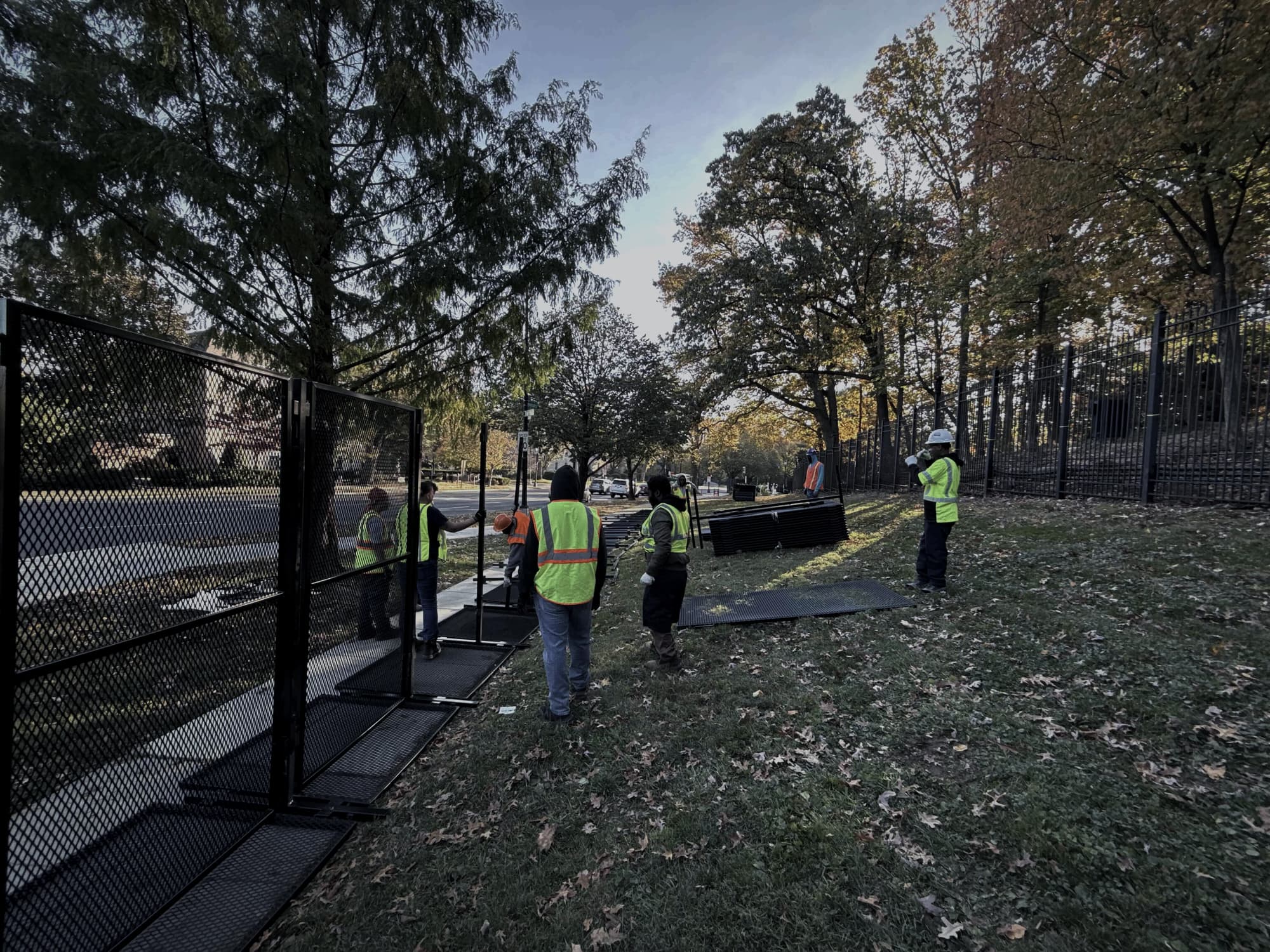 RMR Pro crew in high-visibility vests staging anti-climb fence panels on site
