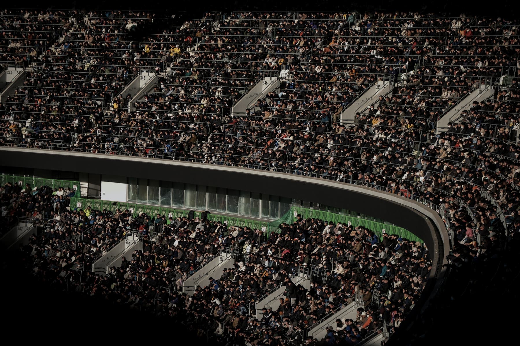 Capacity crowd filling a stadium bowl